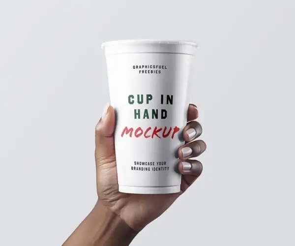 Free Coffee Cup In Hand Mockup (PSD)